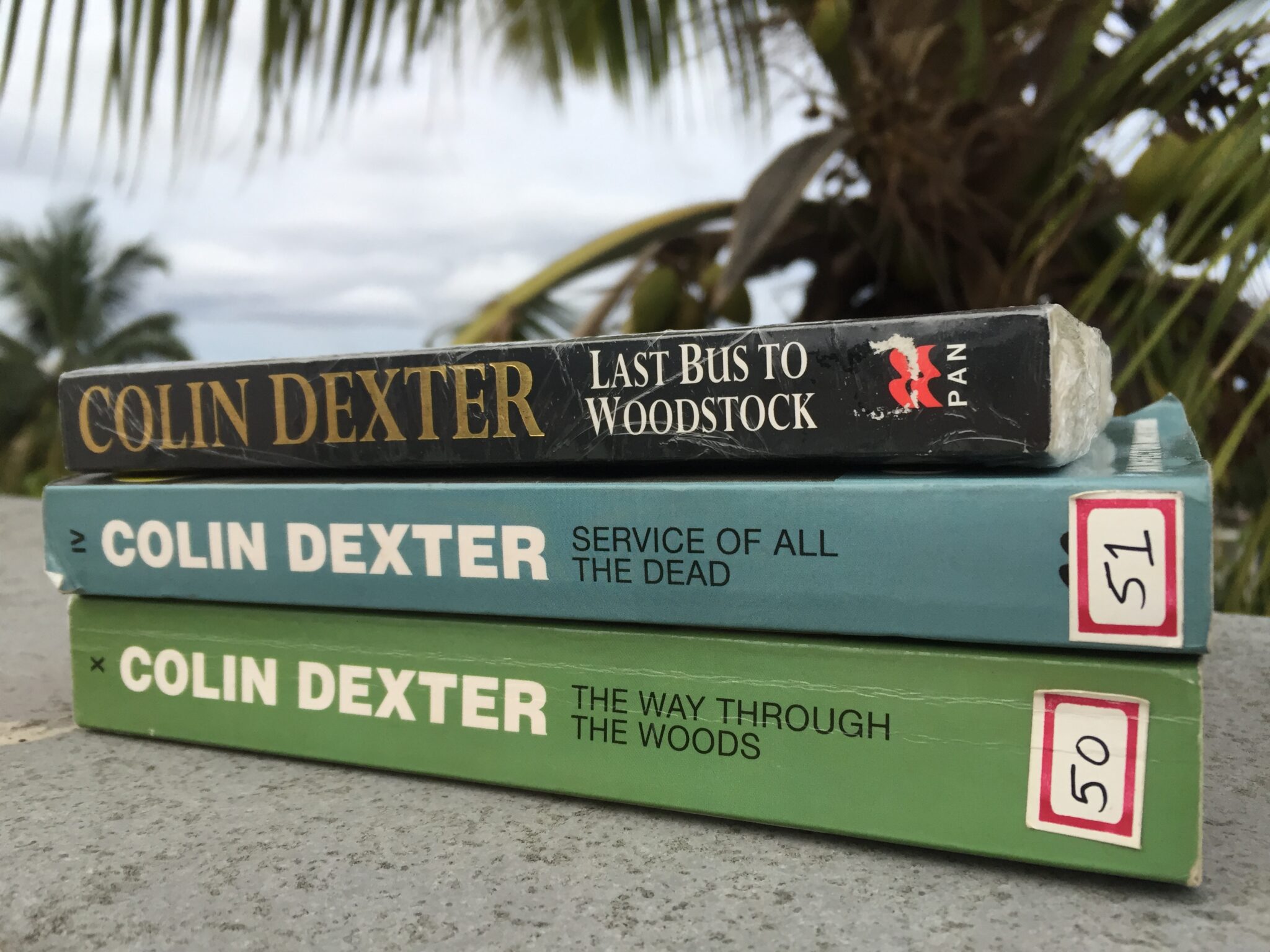 photo of 3 Inspector Morse books on the terrace with coconut tree in background