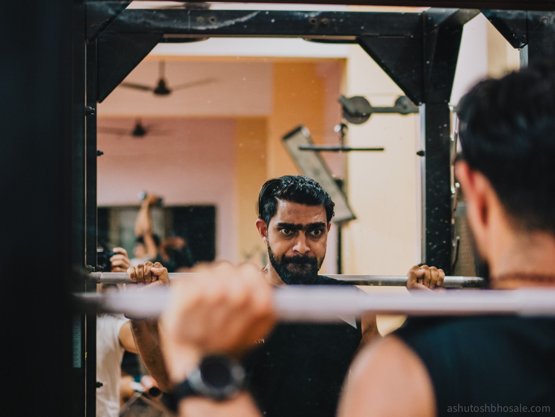 Two brothers talking at the squat rack.